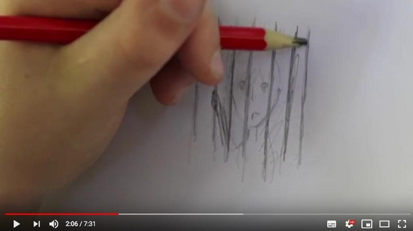 A hand with a red colored pencil draws vertical lines on white paper